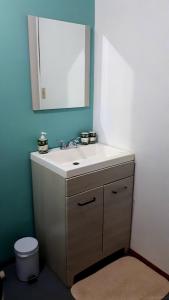 a bathroom with a sink and a mirror at Wettstone Guest Ranch in Bridge Lake