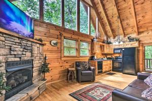 sala de estar con chimenea y TV en Romantic Pigeon Forge Log Cabin with Hot Tub!, en Sevierville