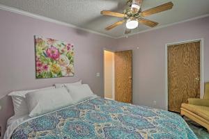 a bedroom with a bed and a ceiling fan at Interlochen Family Home on Green Lake in Interlochen