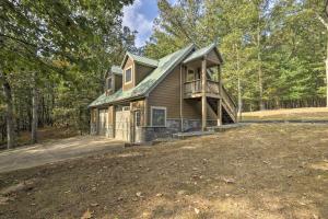 a house with a wrap around porch in the woods at Couples Cabin - 5 Mi to DT Berkeley Springs! in Berkeley Springs