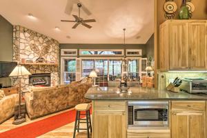 a kitchen and living room with a couch at Stunning Beech Mountain Cabin with Porch and Hearth in Beech Mountain