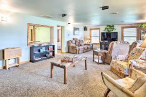 a living room with a couch and a tv at Family Home with Hot Tub - Walk to Johnson Lake! in Donald Price Mobile Home Park