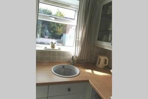 a kitchen counter with a sink and a window at Lavender House in Edwinstowe