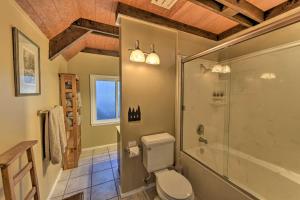 a bathroom with a toilet and a glass shower at Near Vineyards Cabin with Hot Tub in Pollock Pines! in Pollock Pines +21 photos