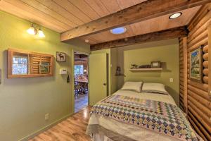 a bedroom with a bed and a wooden ceiling at Amber Cabin with Hot Tub, Near Top Vineyards! in Pollock Pines