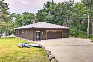 a garage with two umbrellas in front of it at Lakefront Home with Private Dock-15 Mi to Walker in Walker