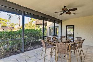 a dining room with a ceiling fan and a table and chairs at Sarasota Villa with Pool Access about 4 Mi to Beach! in Sarasota