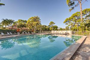 a large swimming pool with chairs and trees at Sarasota Villa with Pool Access about 4 Mi to Beach! in Sarasota