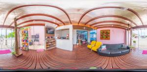 a room with a couch and chairs in a building at Pousada Rosa in Penha