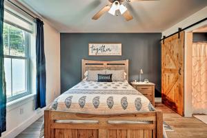 a bedroom with a bed and a ceiling fan at Benezette Cabin with Hot Tub, Grill and Mtn Views in Benezette