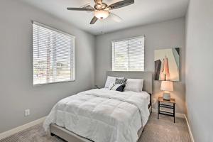 a bedroom with a bed and a ceiling fan at 7 Mi to Dtwn Phoenix Home with Patio and Yard in Phoenix