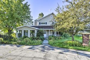 a white house with trees and a driveway at Deck and Fire Pit Waterfront Lake Michigan Escape in Algoma
