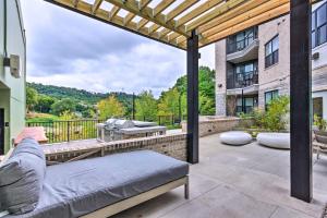an outdoor patio with a couch and a grill at Walkable Downtown Asheville Condo with Balcony in Asheville