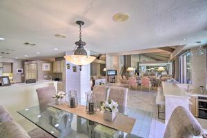 a dining room and kitchen with a glass table and chairs at Luxury Home with Pool and Spa - 3 Mi to Natl Park! in Rancho Mirage