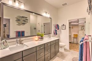a bathroom with two sinks and a large mirror at Walkable Downtown Asheville Condo with Balcony in Asheville +22 photos