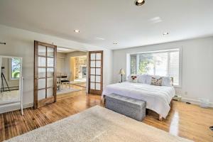 a bedroom with a bed and a large window at Deck and Fire Pit Waterfront Lake Michigan Escape in Algoma