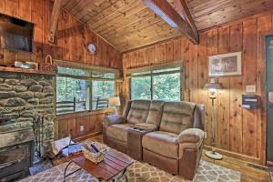 a living room with a couch and a fireplace at Secluded Stanardsville Cabin with 10 Acres and Hot Tub in Stanardsville