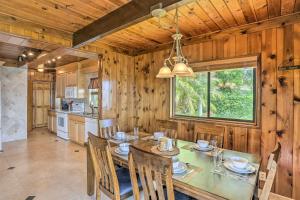 a dining room with a table and chairs and a kitchen at Waterfront Lake Placid Home Game Rm, Dock, Kayaks in Lake Placid