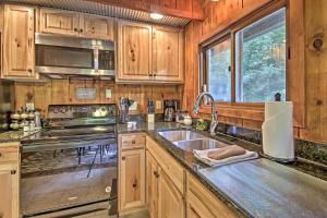 a kitchen with a sink and a stove at Secluded Stanardsville Cabin with 10 Acres and Hot Tub in Stanardsville