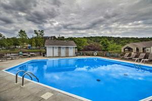 a large blue swimming pool on top of a house at 2 Mi to Silver Dollar City Condo with Fireplace! in Branson