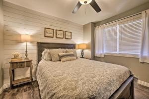 a bedroom with a bed and a ceiling fan at 2 Mi to Silver Dollar City Condo with Fireplace! in Branson +16 photos