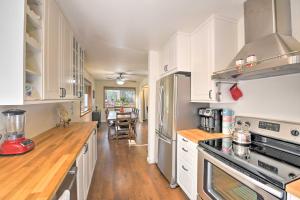 a kitchen with white cabinets and a wooden floor at Cabin in Natl Forest 35 Min to Boreal Resort in Colfax