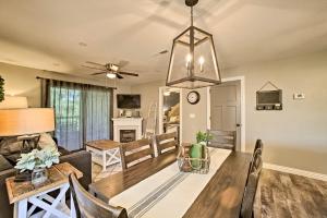 a dining room and living room with a dining table at 2 Mi to Silver Dollar City Condo with Fireplace! in Branson