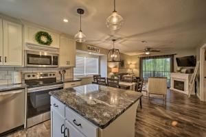 a kitchen with a large island in the middle at 2 Mi to Silver Dollar City Condo with Fireplace! in Branson