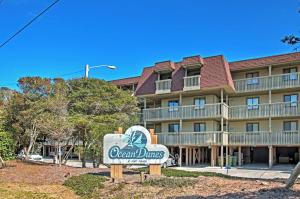 a sign in front of the ocean dunes hotel at Ocean Dunes Kure Beach Condo with Balcony and Pool in Kure Beach