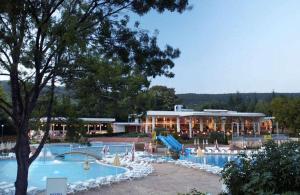 a resort with a slide and a swimming pool at Hotel Com - All Inclusive in Albena