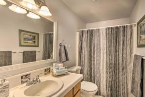 a bathroom with a sink and a toilet and a mirror at Cozy Home By Henderson Bay - 8 Miles to Gig Harbor in Gig Harbor +16 photos