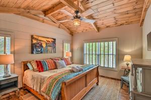 a bedroom with a bed with a wooden ceiling at Cork and Creek Cottage with Mtn and Pasture Views! in Ellijay