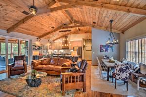 a living room with a couch and a table at Cork and Creek Cottage with Mtn and Pasture Views! in Ellijay
