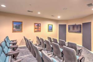 a conference room with chairs and a flat screen tv at Branson Condo on Golf Course, 4 Mi to Downtown in Branson +32 photos