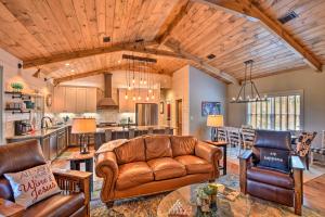 a living room with a couch and a table at Cork and Creek Cottage with Mtn and Pasture Views! in Ellijay