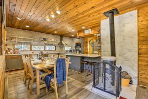 a kitchen and dining room with a table and a stove at Tranquil Dumont Home with Creek and Mtn Views! in Dumont