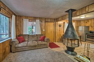 a living room with a couch and a stove at 2 Cozy Island Park Cabins with Near the Lake! in Island Park