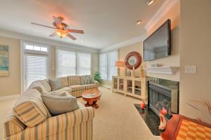 a living room with a couch and a tv and a fireplace at Manteo Waterfront Resort Home with 30-Ft Dock! in Manteo