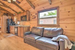 a living room with a leather couch in a cabin at Mill Spring Cabin Near Parker-Binns Winery! in Mill Spring