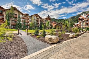 a resort with a stone walkway and rocks at Ski-In and Ski-Out Solitude Condo with Rooftop Hot Tub! in Salt Lake City