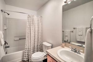 a white bathroom with a sink and a toilet at Home with Yard 1 Mi to Indian Rocks Beach and Golf in Largo +18 photos