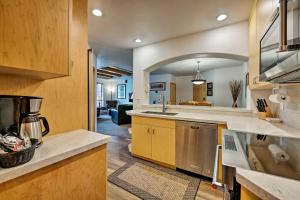 a large kitchen with a sink and a stove at Ski-InandSki-Out Solitude Condo with Rooftop Hot Tub! in Salt Lake City