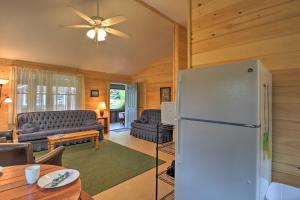 cocina y sala de estar con nevera blanca en Family Cabin with Beach Access on Panther Pond, en Raymond