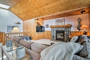a living room with a couch and a fireplace at Dock Access and Hot Tub Waterfront Meeks Bay Home in Tahoma