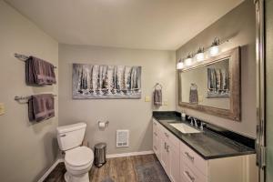 a bathroom with a toilet and a sink and a mirror at Lake Pend Oreille Home with Dock and Paddle Boards in Sagle +21 photos