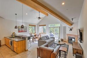 a kitchen and living room with a couch and a table at Riverfront Silverthorne Condo Near Skiing! in Silverthorne