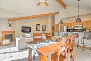 a kitchen and living room with a table and chairs at Riverfront Silverthorne Condo with Balcony and Grill! in Silverthorne