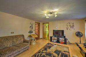 a living room with a couch and a flat screen tv at Catskill Mtn Home with Deck about 1 Miles to Zoom Flume! in East Durham