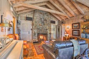 a living room with a stone fireplace and leather furniture at Hot Tub and Lake Tahoe Views Kings Beach Lodge in Kings Beach