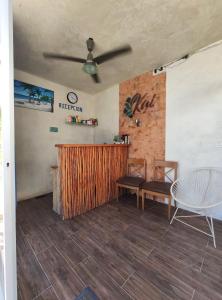a room with a bar and a table and chairs at Kai Hotel Boutique Adults Only in Holbox Island